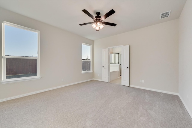 carpeted spare room with ceiling fan