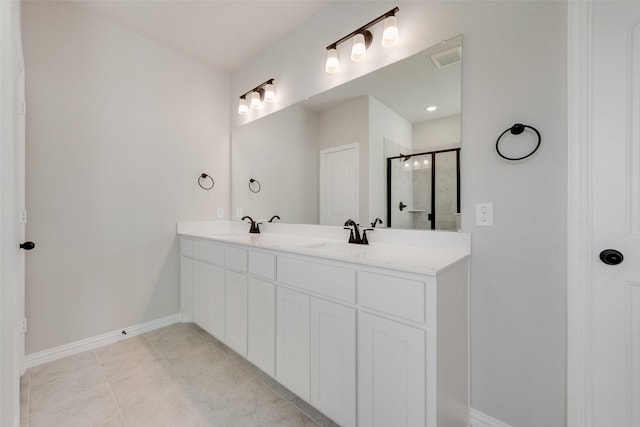 bathroom featuring tile patterned floors, vanity, and a shower with shower door