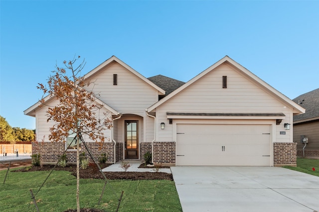 view of front of property with a garage and a front lawn