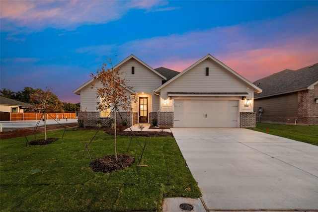 view of front of house with a yard and a garage