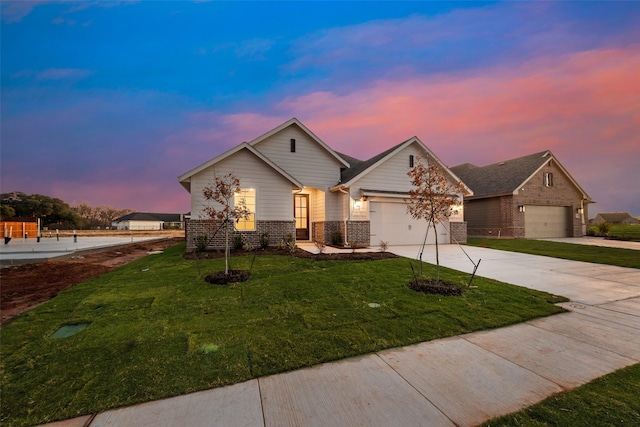 view of front of property featuring a garage and a yard