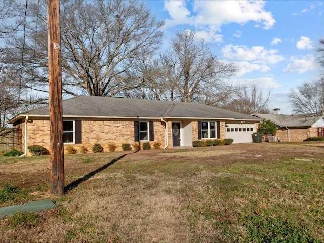 single story home featuring a front yard and a garage