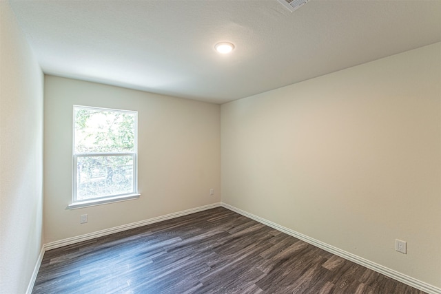 unfurnished room with dark hardwood / wood-style floors