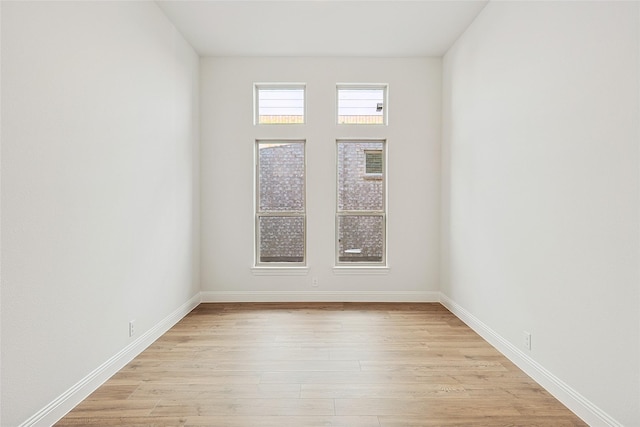 empty room with light hardwood / wood-style flooring