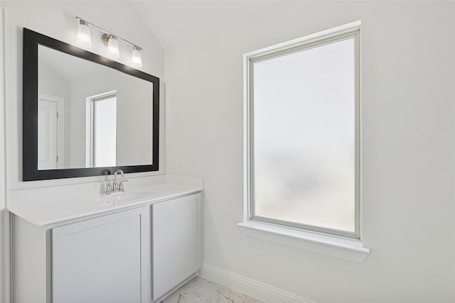 bathroom featuring vanity and lofted ceiling