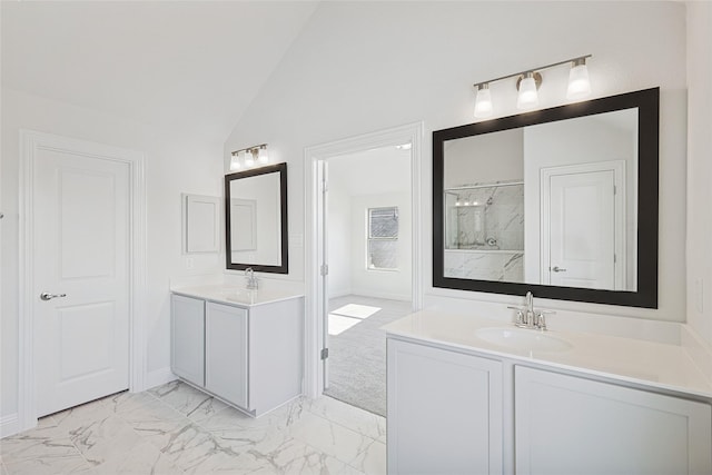 full bathroom featuring a sink, a marble finish shower, marble finish floor, two vanities, and lofted ceiling