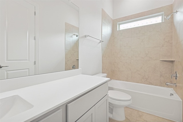 full bathroom with toilet, vanity, and tiled shower / bath