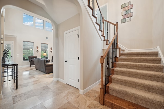 foyer featuring high vaulted ceiling and plenty of natural light