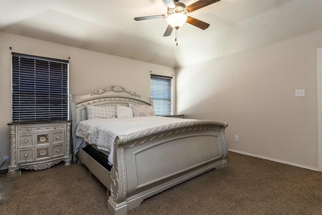 bedroom with vaulted ceiling, dark colored carpet, and ceiling fan