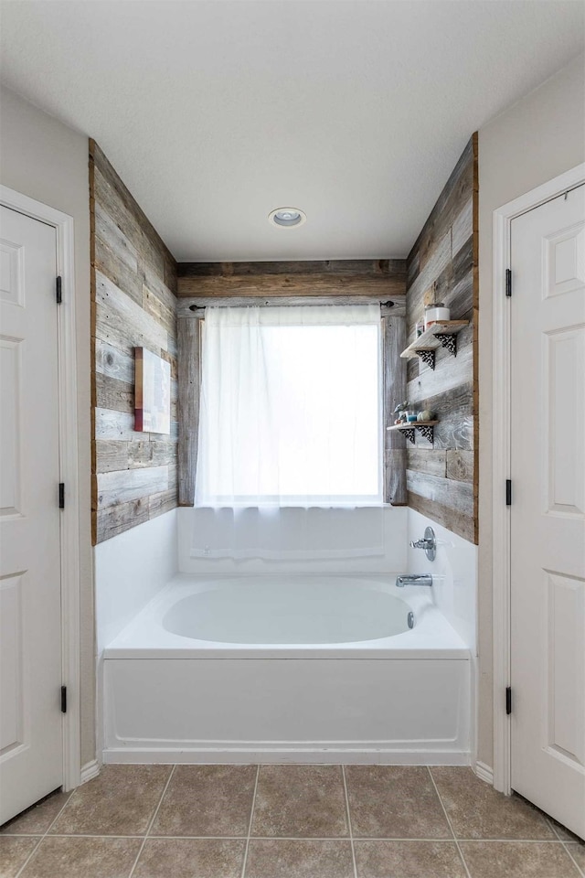 bathroom featuring a tub and tile patterned floors