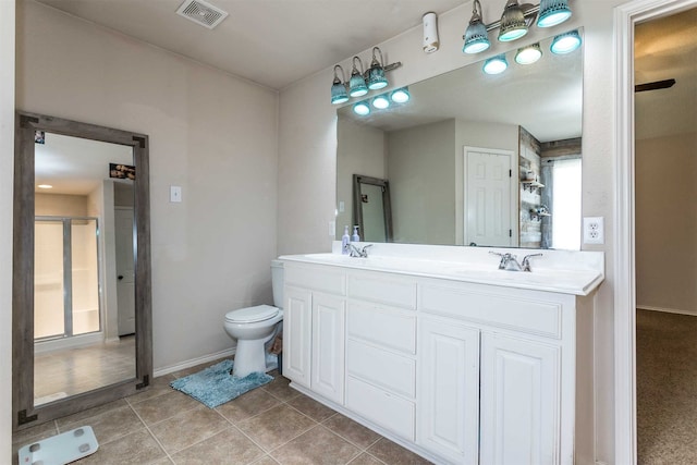 bathroom with tile patterned floors, toilet, plenty of natural light, and vanity