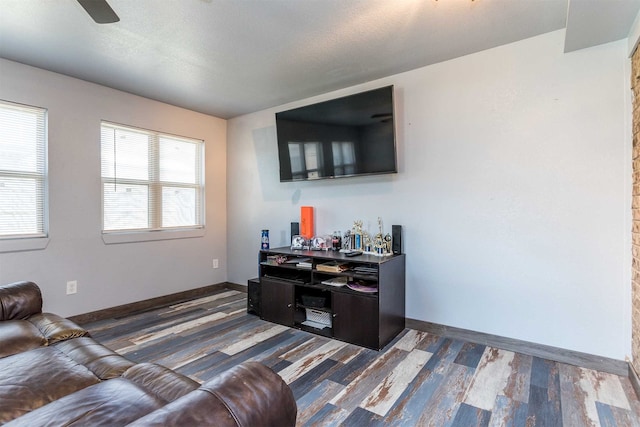 living room featuring a textured ceiling, ceiling fan, and dark hardwood / wood-style floors