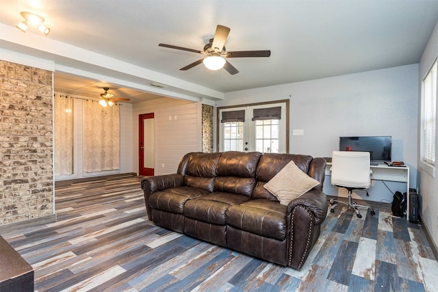 living room featuring ceiling fan, wood-type flooring, and french doors