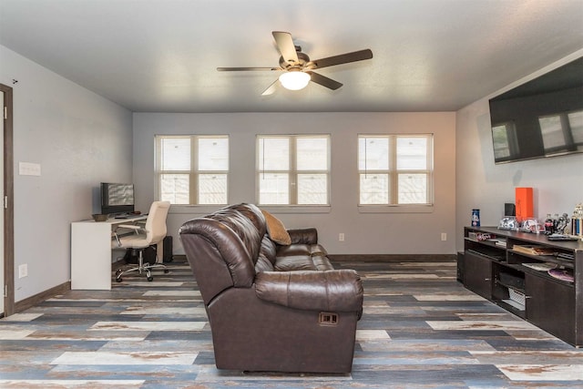 living room featuring dark hardwood / wood-style flooring, plenty of natural light, and ceiling fan