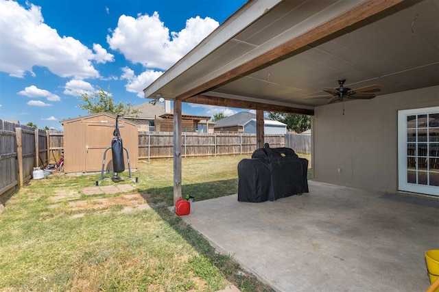 view of yard with ceiling fan, a patio, and a shed