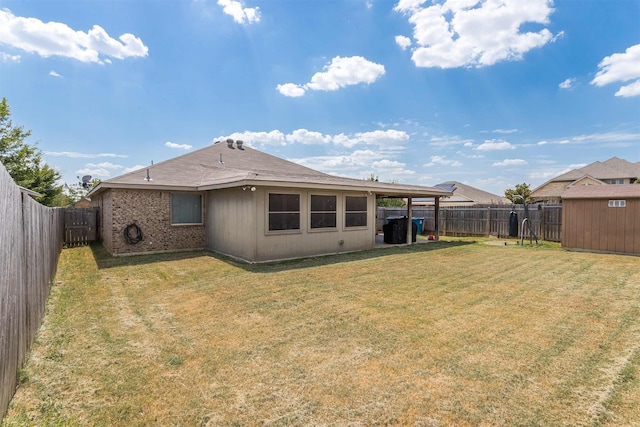 rear view of house with a yard