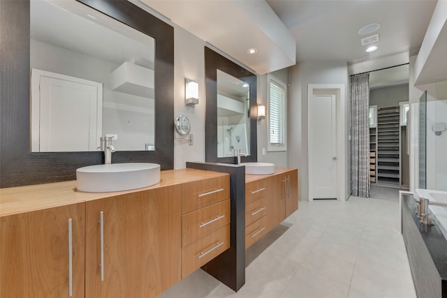 bathroom with tile patterned flooring and vanity