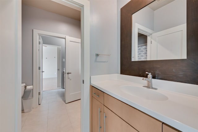 bathroom featuring tile patterned floors, vanity, and toilet