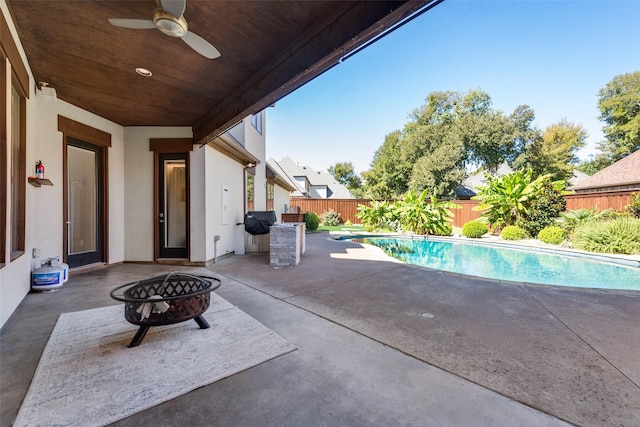 view of swimming pool featuring a patio and ceiling fan