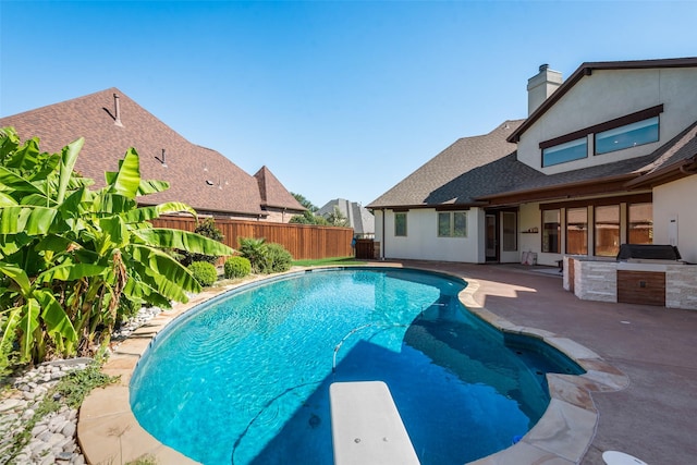 view of pool featuring area for grilling and a patio area