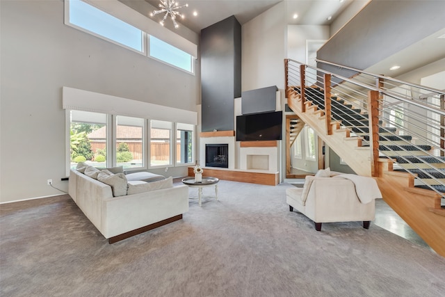 living room with carpet flooring, a high ceiling, and a chandelier