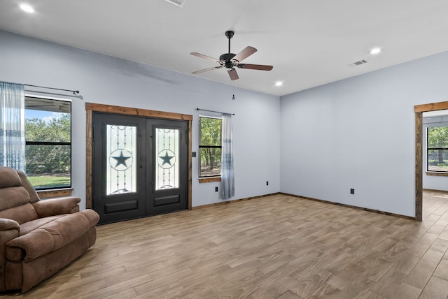 entryway featuring ceiling fan, light wood-type flooring, and french doors