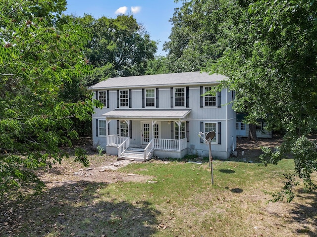 colonial-style house with a front yard and a porch