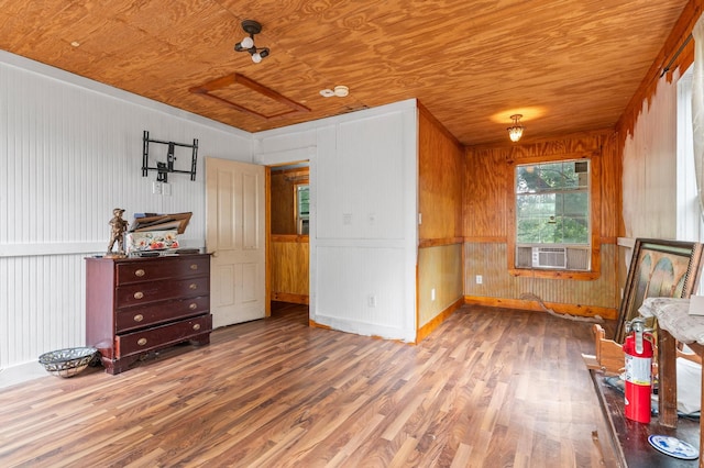 interior space with wood ceiling, wood walls, and light hardwood / wood-style floors