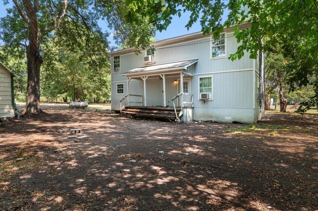 back of house featuring cooling unit