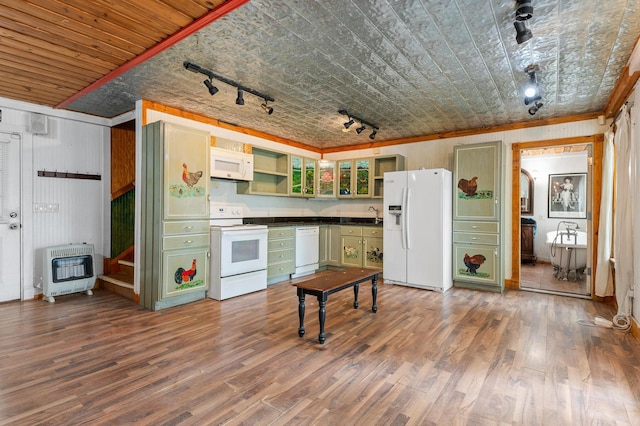 kitchen with white appliances, wood walls, track lighting, and hardwood / wood-style flooring