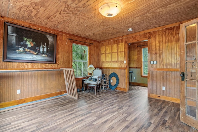 sitting room with hardwood / wood-style flooring, wooden walls, and wooden ceiling