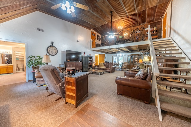 carpeted living room with a fireplace, vaulted ceiling, ceiling fan, and wood ceiling