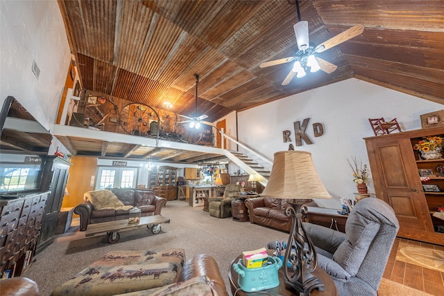 living room with a wealth of natural light, ceiling fan, and carpet floors