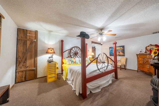 bedroom with a textured ceiling, ceiling fan, and carpet