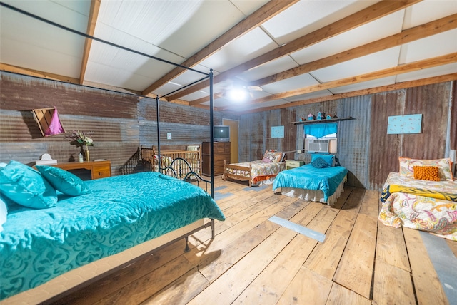 bedroom with cooling unit, beamed ceiling, wooden walls, and hardwood / wood-style flooring