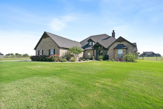 french country inspired facade with a front yard