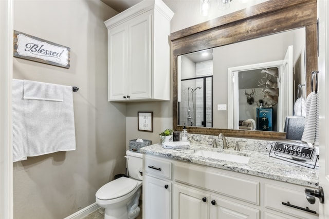 bathroom featuring walk in shower, vanity, and toilet