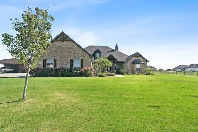 french country home featuring a front lawn