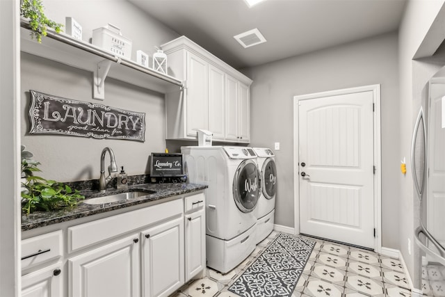 washroom featuring cabinets, washer and dryer, and sink