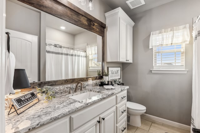 bathroom with wood-type flooring, vanity, and toilet