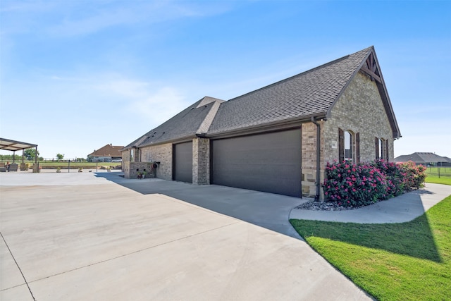 view of side of property with a garage