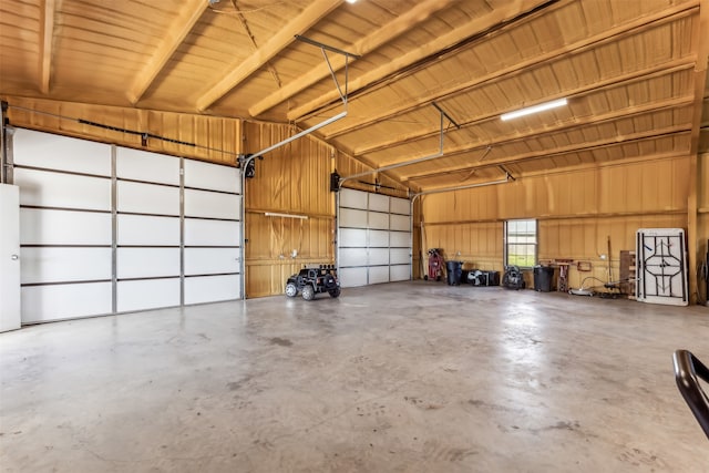 garage featuring wooden walls and wooden ceiling