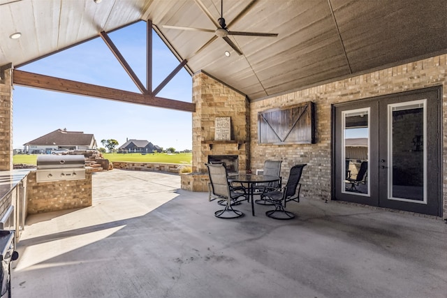 view of patio / terrace with ceiling fan, an outdoor kitchen, and grilling area