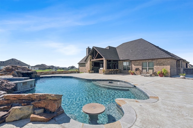 view of swimming pool featuring an in ground hot tub and a patio area