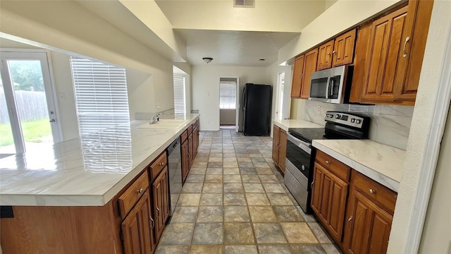 kitchen with black appliances and decorative backsplash