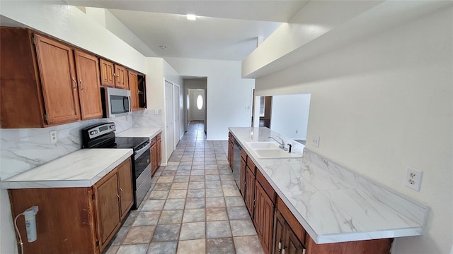 kitchen featuring appliances with stainless steel finishes, sink, and decorative backsplash