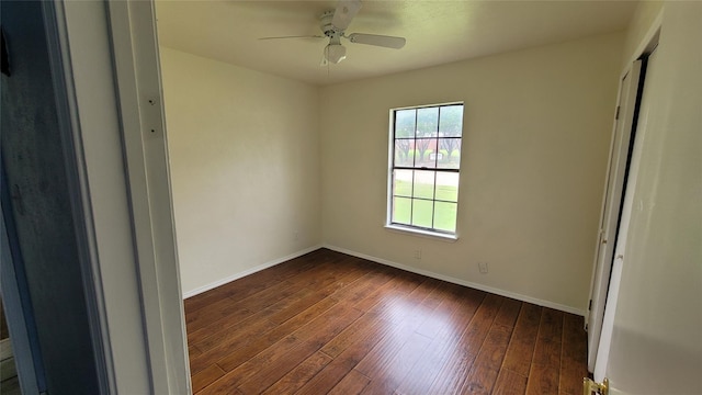 empty room with ceiling fan and dark hardwood / wood-style flooring