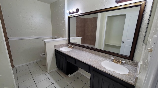 bathroom with vanity, toilet, and tile patterned floors