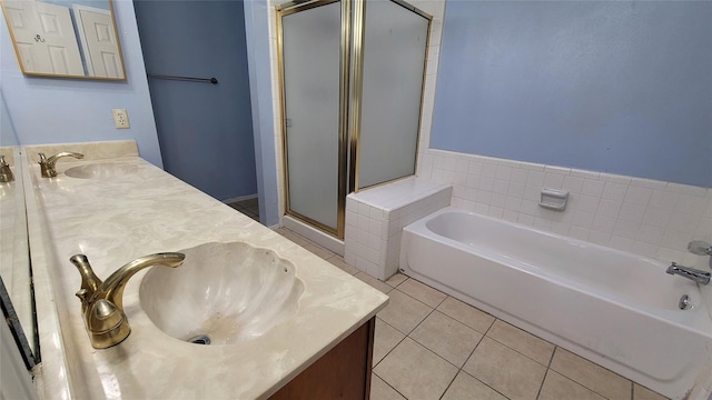 bathroom with plus walk in shower, tile patterned flooring, and vanity