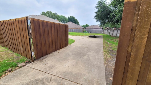 view of gate with a patio area